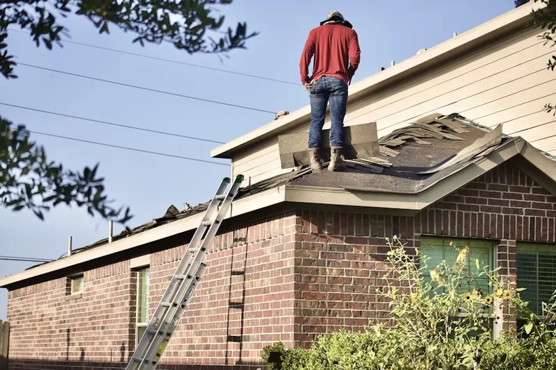 Professional roofer working on a residential roof in Clarks Mill